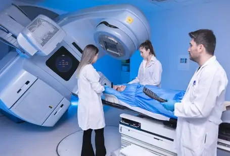 Medical team operating a radiation therapy machine