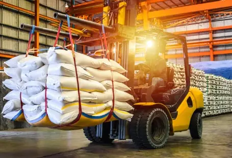 Warehouse forklift lifting heavy cargo sacks