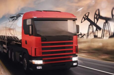 Semi truck with oil field pumpjacks in the background