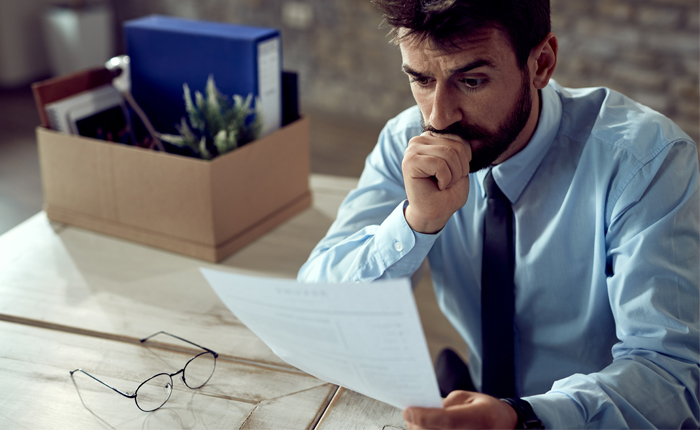 Worried businessman going through paperwork