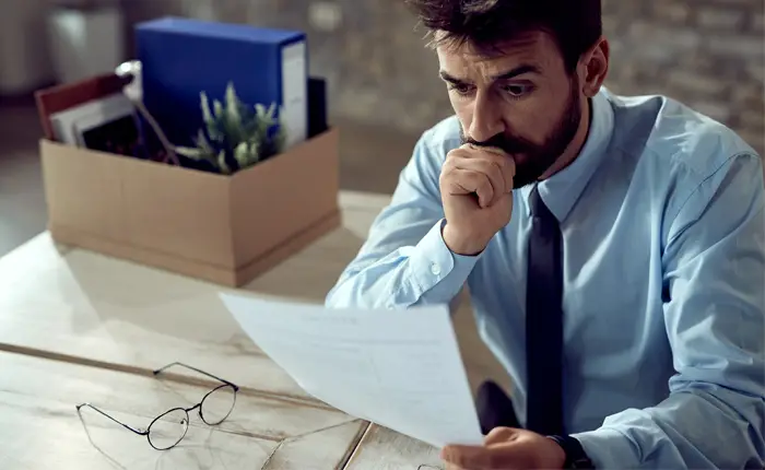 Worried businessman going through paperwork