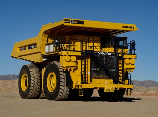 Large yellow Komatsu 730E haul truck parked on a dirt lot, representing a successful $6.5 million heavy equipment financing deal in Ohio.