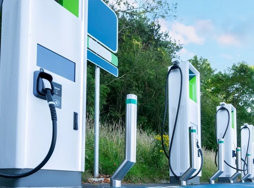 A row of modern electric vehicle charging stations installed outdoors.